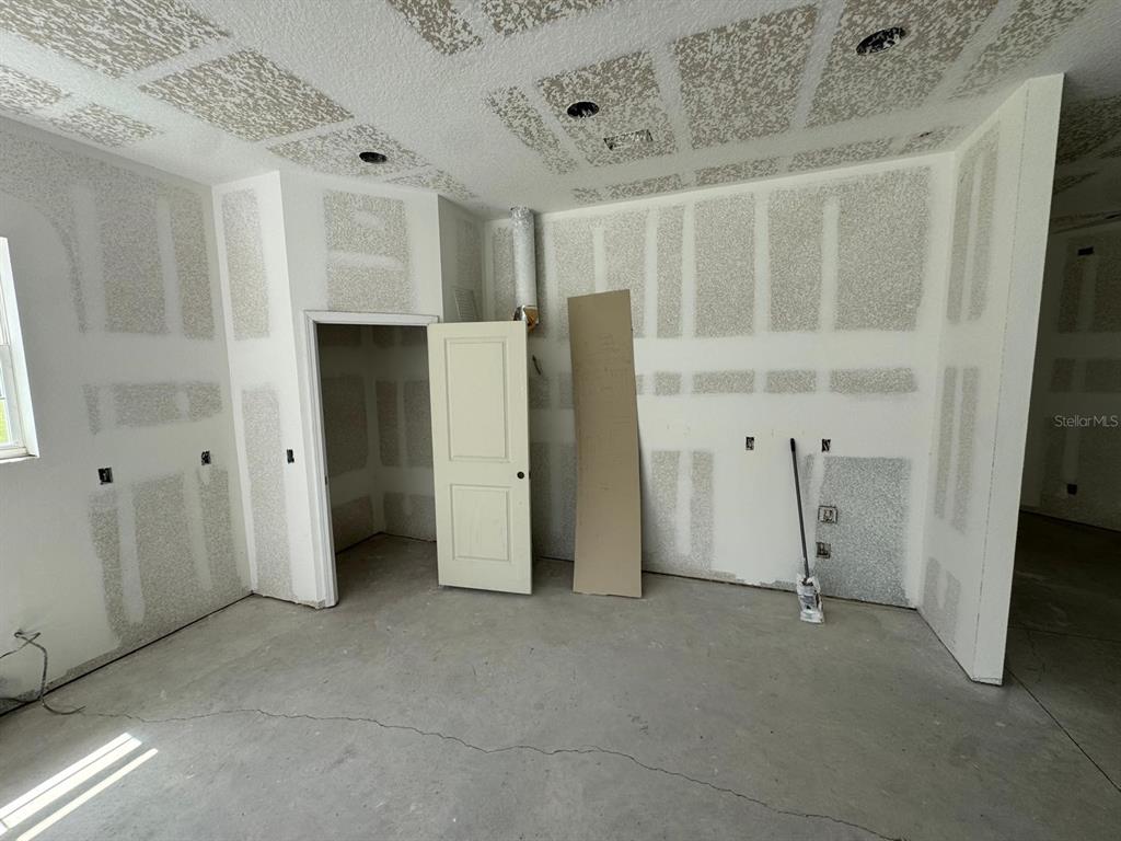 An unfinished room with drywall, a closet, and a concrete floor — 6701 OLD MELBOURNE HIGHWAY UNIT A, ST CLOUD, FL
