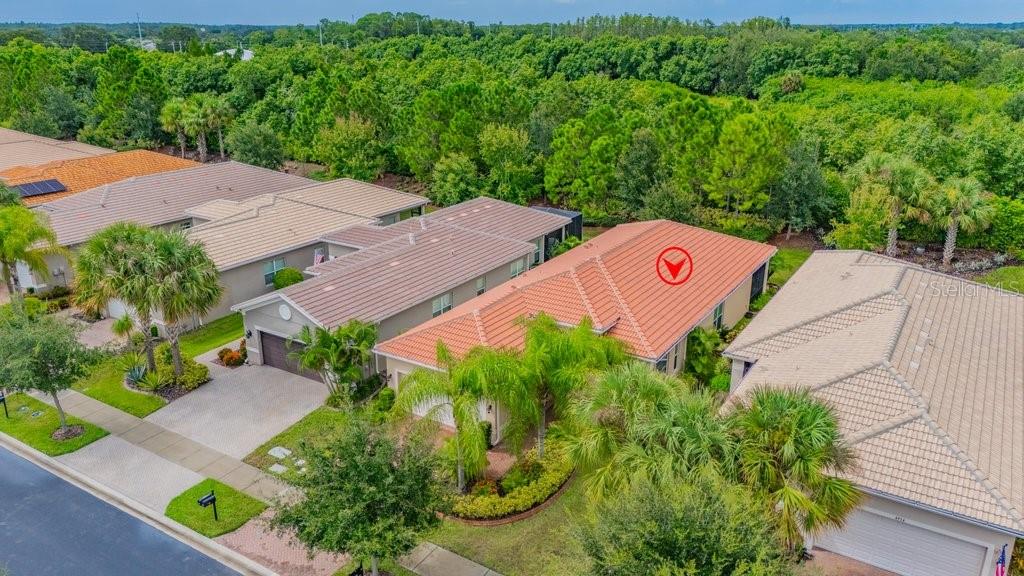 An aerial view of a suburban neighborhood featuring houses with tiled roofs and lush landscaping — 4952 SANDY GLEN WAY, WIMAUMA, FL