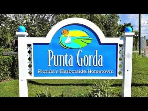 A white sign with blue lettering identifies the city of Punta Gorda, Florida — 141 GLENHOLM AVENUE, PUNTA GORDA, FL