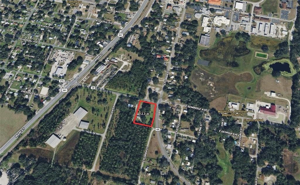 An aerial map shows a 2.3-acre property outlined in red near a highway and town — 309 S CENTER STREET, BUSHNELL, FL
