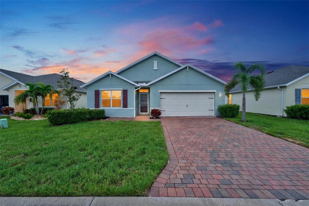 A single-story house with a paved driveway, a two-car garage, and a green lawn — 4107 MANATEE LANE, PUNTA GORDA, FL