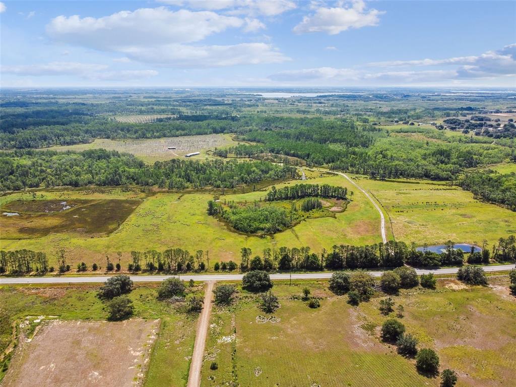 An aerial view of a large, rural plot of land featuring fields, trees, and roads — 0 ST RD 557, LAKE ALFRED, FL