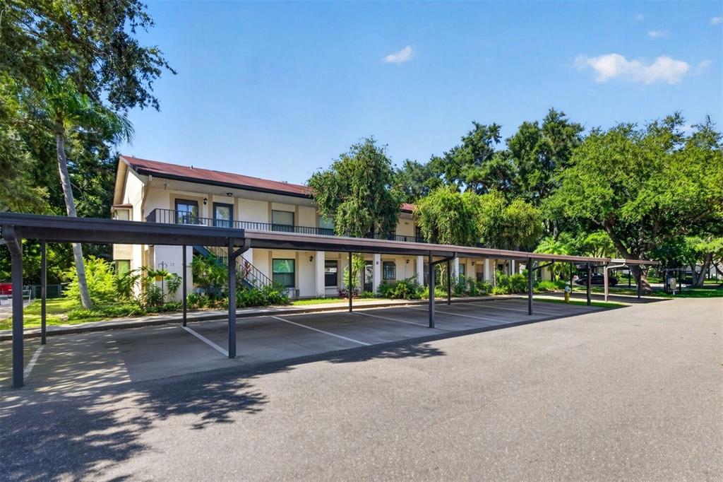A two-story apartment building with a covered parking structure in the foreground — 11511 113TH STREET UNIT 13F, SEMINOLE, FL