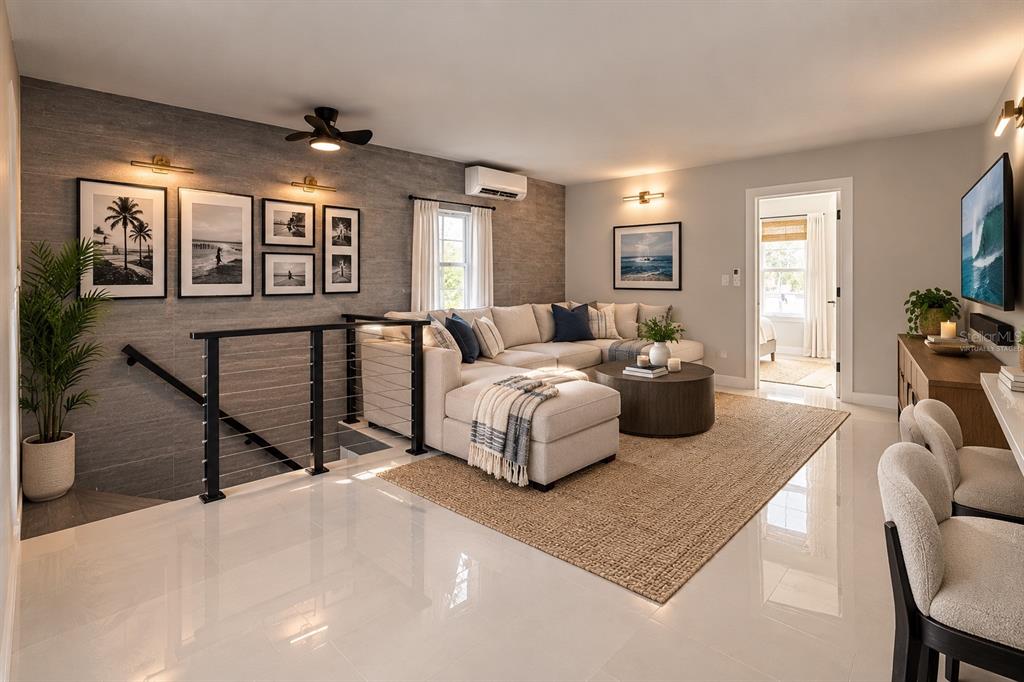 A modern kitchen features white cabinetry, stainless steel appliances, a quartz island, and gray stools — 1427 ASHER LANE, ORLANDO, FL