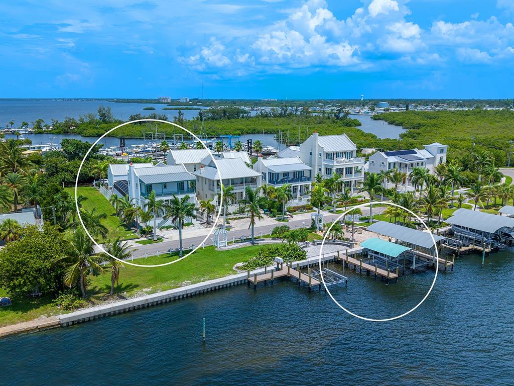 An aerial view shows waterfront houses with private boat docks and palm trees — 4024 11TH STREET COURT W, PALMETTO, FL