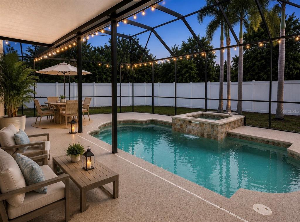 A screened-in patio features a swimming pool, a raised spa, and outdoor seating at dusk — 6801 CAMBRIDGE PARK DRIVE, APOLLO BEACH, FL