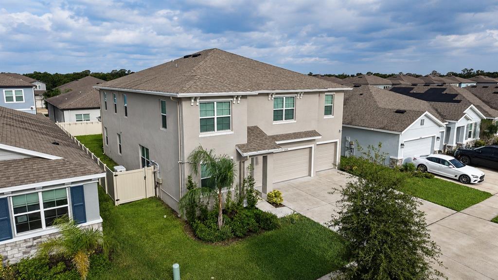 An aerial view shows a two-story suburban house with a tan exterior and gray roof — 12455 SHINING WILLOW STREET, RIVERVIEW, FL
