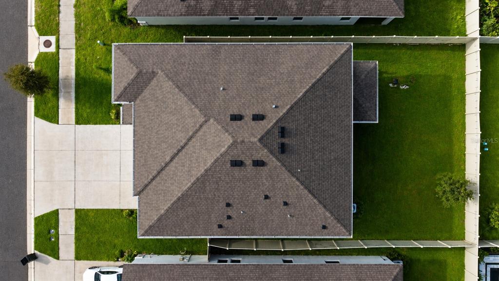 An aerial view shows the shingled roof of a residential house with a fenced backyard — 12455 SHINING WILLOW STREET, RIVERVIEW, FL