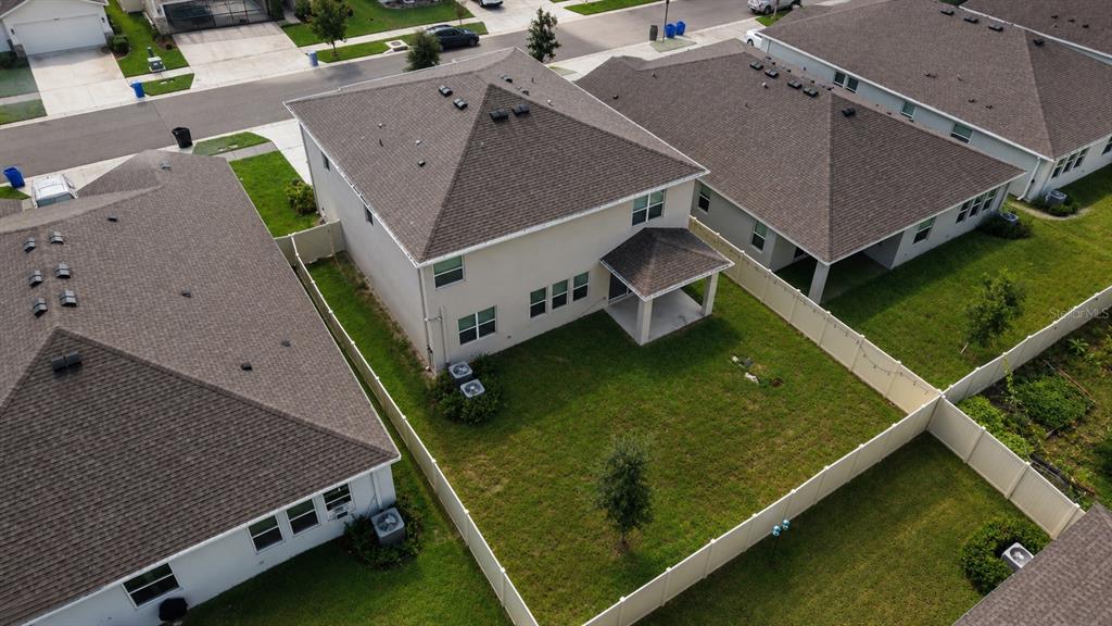 An aerial view shows the backyard and rear exterior of a two-story suburban house — 12455 SHINING WILLOW STREET, RIVERVIEW, FL
