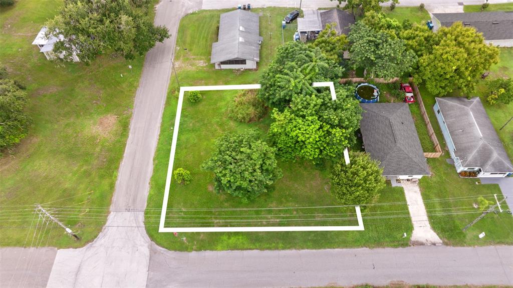 An aerial view shows a vacant, grass-covered residential lot outlined in white — FRENCH AVENUE S, FORT MEADE, FL