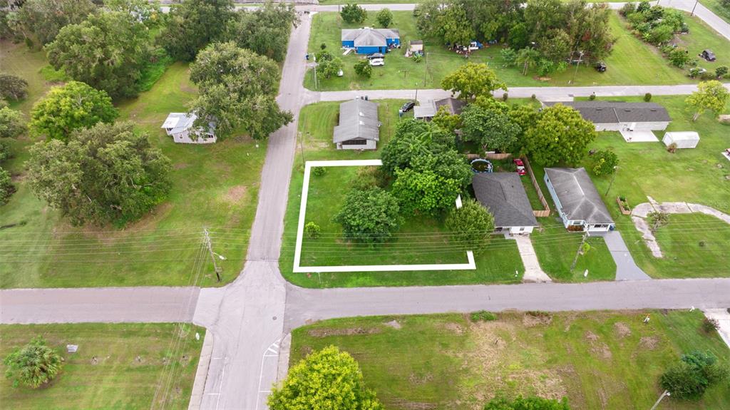 An aerial view shows a vacant residential lot outlined in white next to a house — FRENCH AVENUE S, FORT MEADE, FL