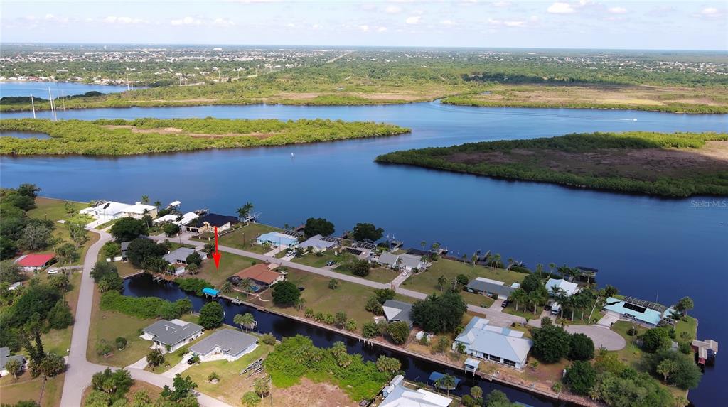An aerial view shows a residential neighborhood with houses situated along a canal and waterway — 2060 RIVER BASIN TERRACE, PUNTA GORDA, FL