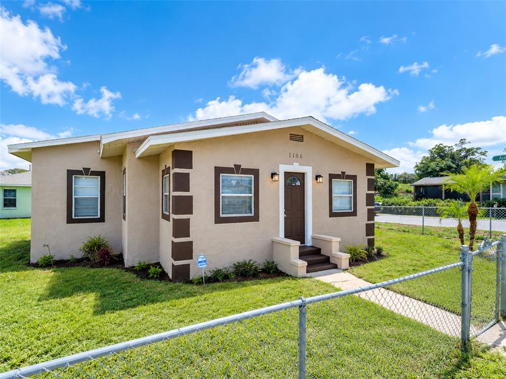 A tan single-story house with brown trim and a chain-link fence in the front yard — 1101 DR MARTIN L KING JR WAY, HAINES CITY, FL