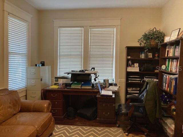 A home office features a wooden desk, a leather sofa, and a tall bookcase — 806 W DE LEON STREET, TAMPA, FL