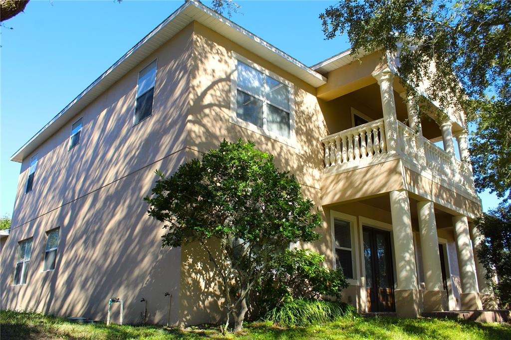 A two-story stucco house with a columned front porch and a second-floor balcony — 13019 SUMMERLAKE WAY, CLERMONT, FL