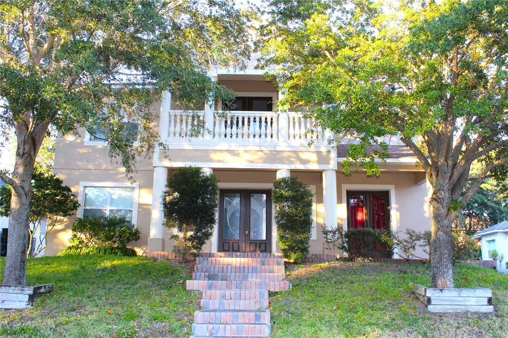 A two-story house with a brick staircase leading to a double front door and balcony — 13019 SUMMERLAKE WAY, CLERMONT, FL