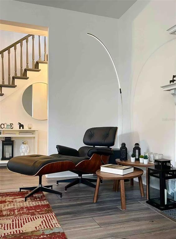 A living area features a black leather lounge chair, a curved floor lamp, and wood flooring — 505 S MYRTLE AVENUE, SANFORD, FL