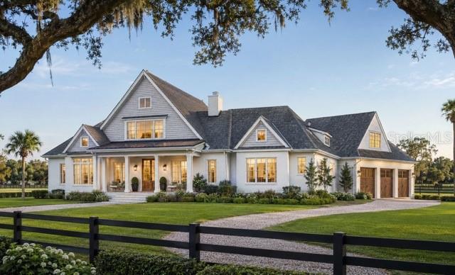 A large, two-story white farmhouse with a gray shingled roof and a gravel driveway — Lot 2 SW 161 TERRACE, NEWBERRY, FL