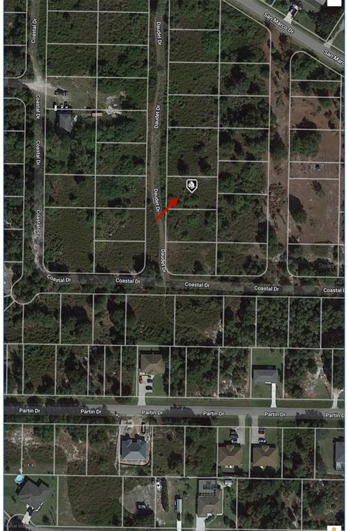 This is an aerial map showing a vacant residential lot highlighted by a red arrow — 1508 DAUDET DRIVE, PUNTA GORDA, FL