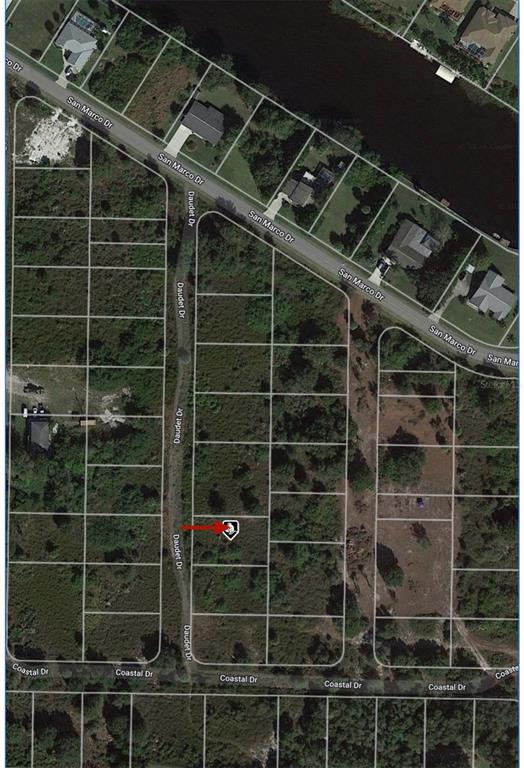 This is an aerial map showing a vacant residential lot marked with a red arrow — 1508 DAUDET DRIVE, PUNTA GORDA, FL