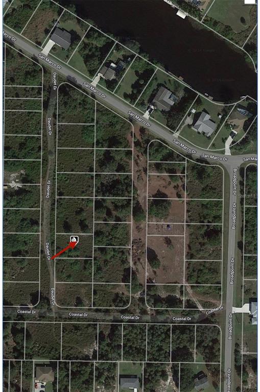 This is an aerial map showing a vacant residential lot marked with a red arrow — 1508 DAUDET DRIVE, PUNTA GORDA, FL