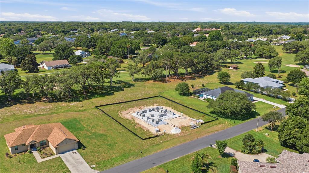 An aerial view of a single-story house under construction with a wooden roof frame — 804 E EPSOM COURT, HERNANDO, FL