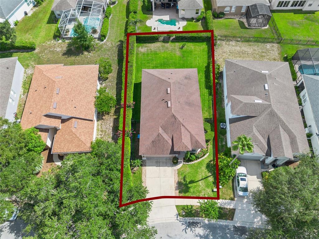 An aerial view shows a single-family home with a fenced backyard and a concrete driveway — 1206 CHESSINGTON CIRCLE, LAKE MARY, FL