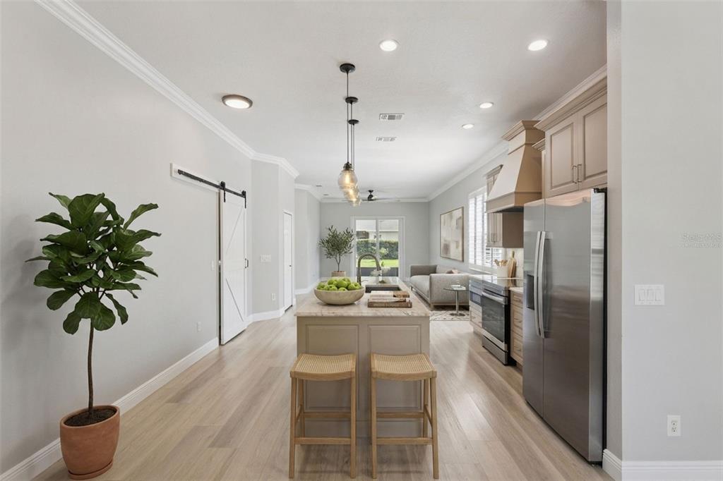 A kitchen with a central island, stainless steel appliances, and light wood flooring — 1206 CHESSINGTON CIRCLE, LAKE MARY, FL
