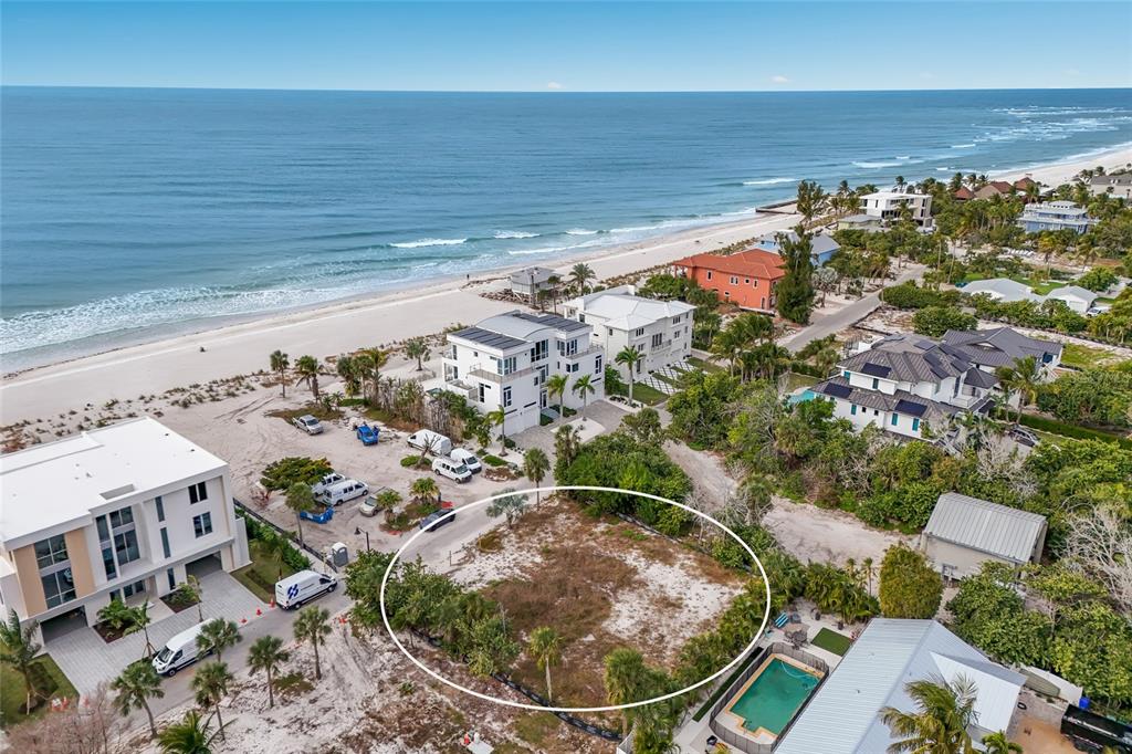 An aerial view shows a vacant, sandy lot circled in white near a beach — 6500 GULFSIDE ROAD, LONGBOAT KEY, FL