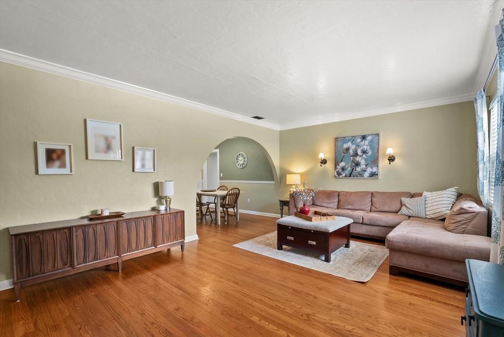 A living room features hardwood floors, a brown sectional sofa, and an arched entryway — 37 E VANDERBILT STREET, ORLANDO, FL