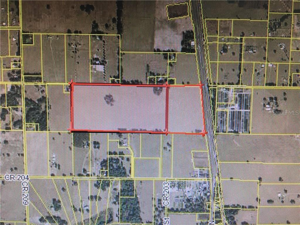 This is an aerial map showing a rectangular parcel of land outlined in red — US HIGHWAY 301, OXFORD, FL