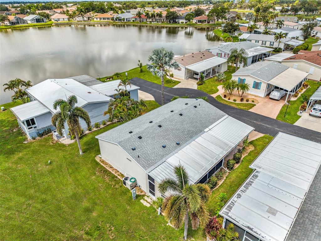 An aerial view of a residential neighborhood featuring manufactured homes near a lake — 1000 KINGS HIGHWAY UNIT 380, PORT CHARLOTTE, FL