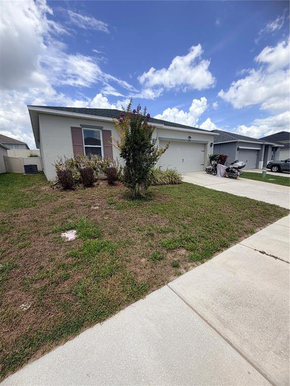 A single-story house with a garage, a driveway, and a small front yard — 297 MEADOWBROOK BOULEVARD, WINTER HAVEN, FL