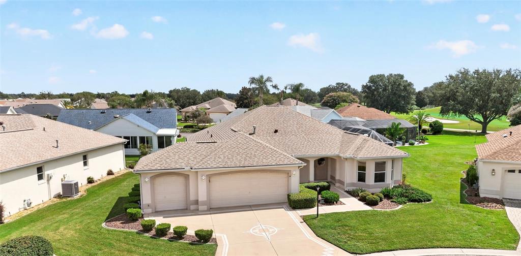 An aerial view of a single-story suburban house with a three-car garage and lawn — 3147 MANSFIELD STREET, THE VILLAGES, FL