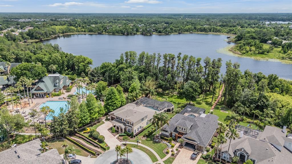 The gated entrance to the Nature's Ridge community features stone pillars and lush landscaping — 21246 QUIET HAVEN COURT, LAND O LAKES, FL