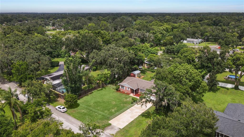 An aerial view shows a single-story house with a large lawn and a concrete driveway — 1805 DIERKER DRIVE, VALRICO, FL