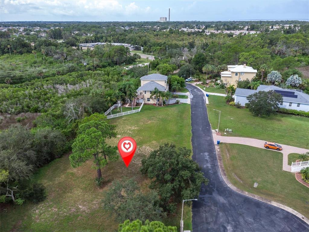 An aerial view shows a vacant lot with a red location pin near a road — 3034 SHEPPARDS CROOK, HOLIDAY, FL