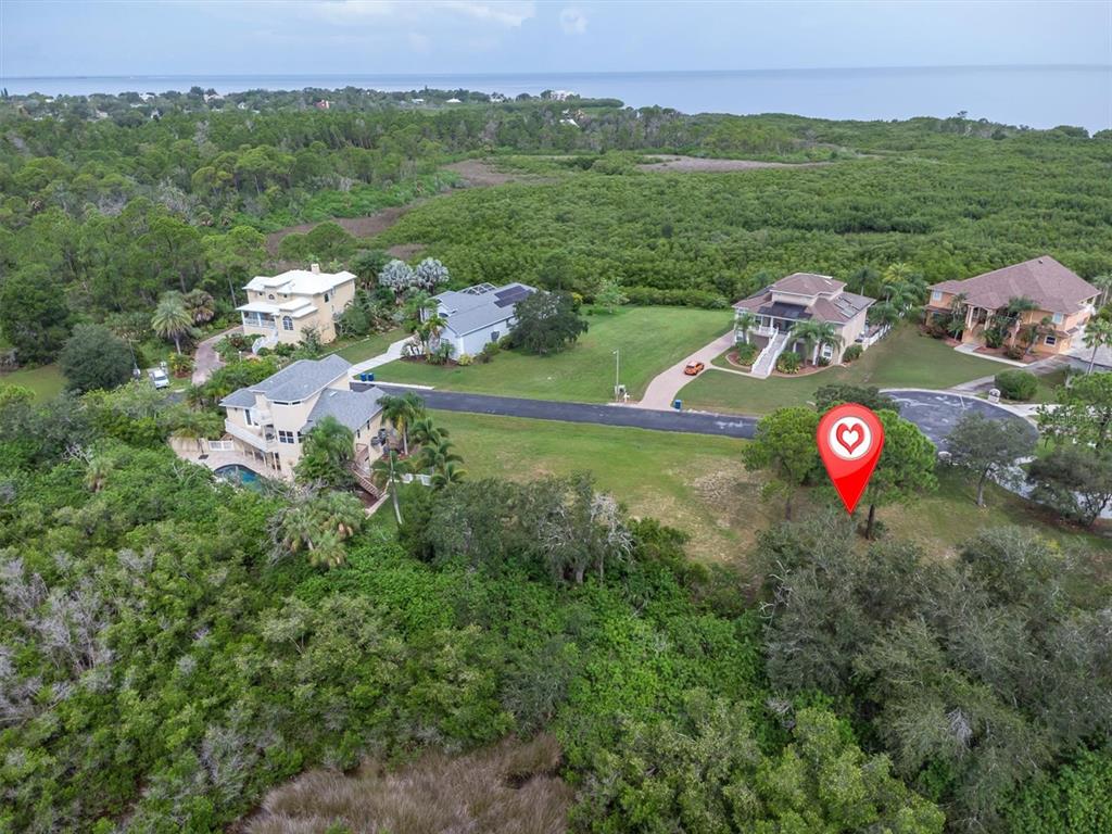 An aerial view shows a vacant lot marked with a pin near several residential homes — 3034 SHEPPARDS CROOK, HOLIDAY, FL