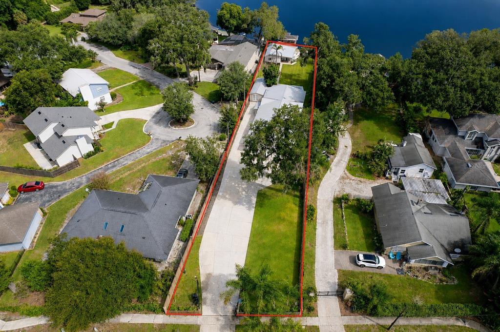 An aerial view shows a long, narrow residential property extending from the street to water — 503 GATLIN AVENUE, ORLANDO, FL