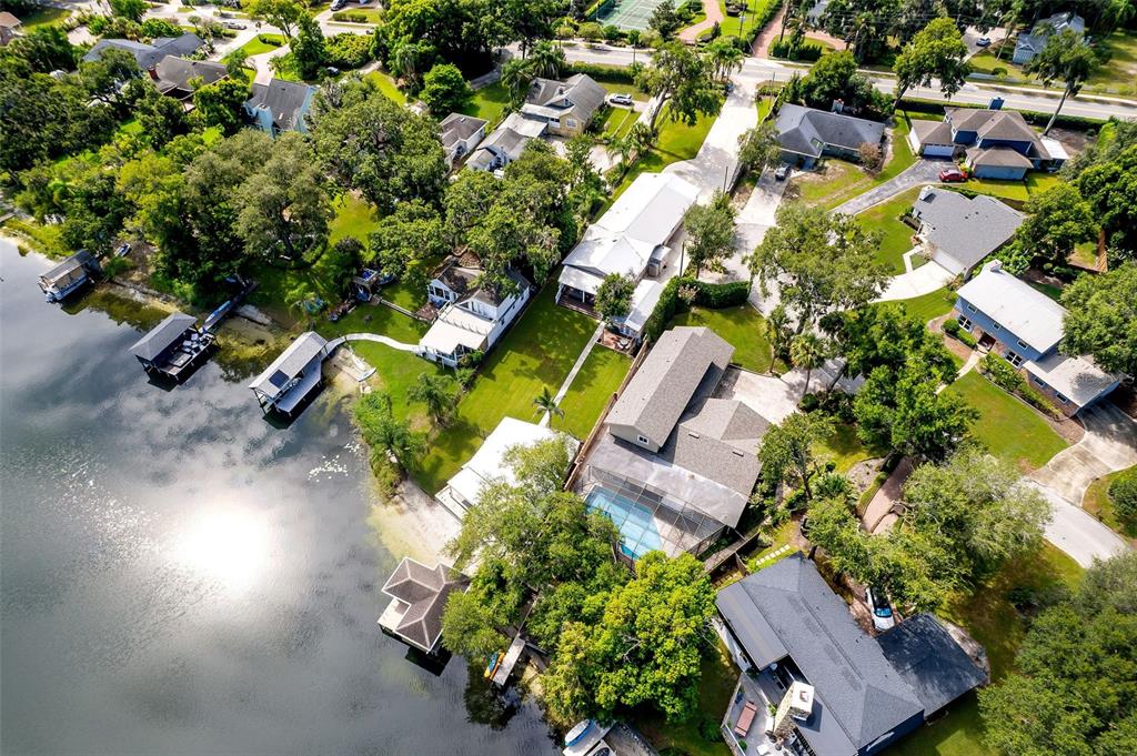 An aerial view shows several waterfront homes with docks, swimming pools, and lush green landscaping — 503 GATLIN AVENUE, ORLANDO, FL