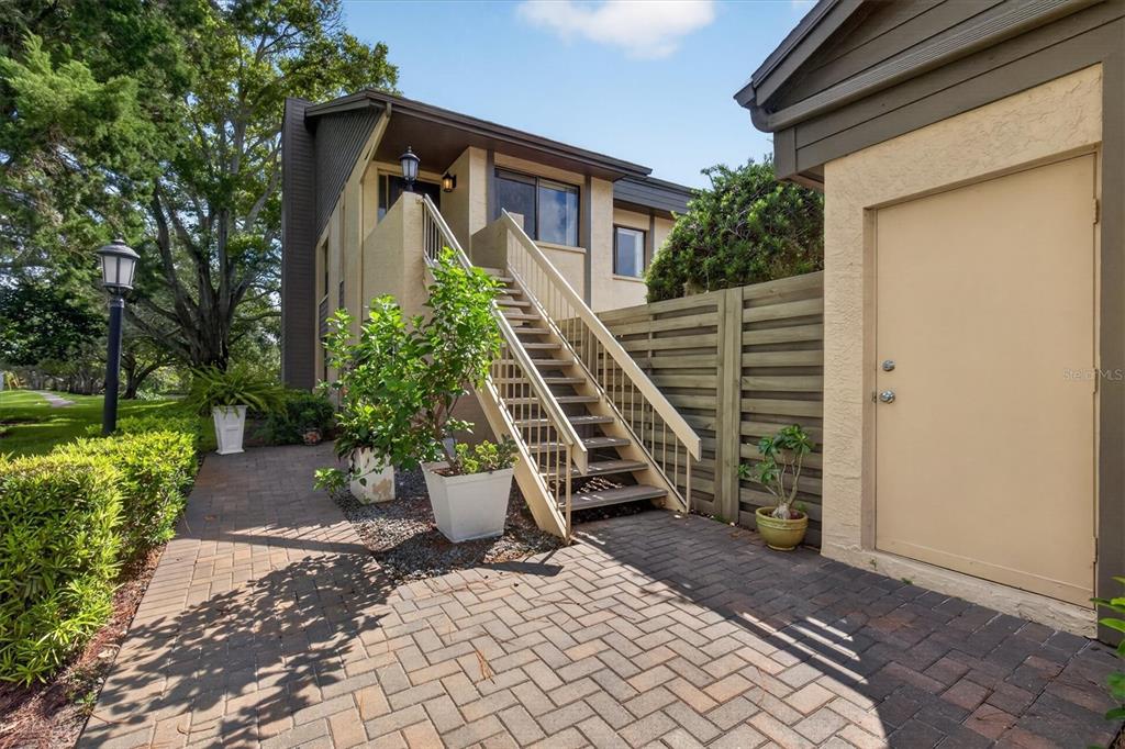 An exterior view of a multi-unit apartment complex with a landscaped entrance sign — 3167 LANDMARK DRIVE UNIT 821, CLEARWATER, FL
