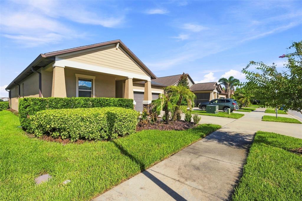 An aerial view shows a tan suburban house with a dark roof and a two-car garage — 9189 SHADYSIDE LANE, LAND O LAKES, FL