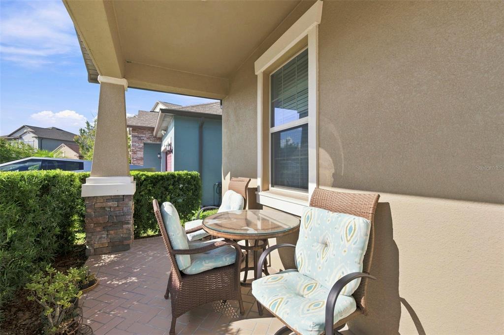 A tan suburban house with a front lawn, a small tree, and a concrete driveway — 9189 SHADYSIDE LANE, LAND O LAKES, FL