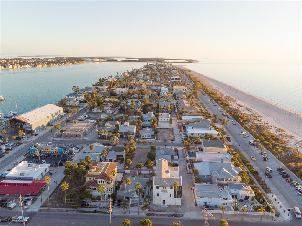 An aerial view shows a narrow coastal town situated between a bay and the ocean — 108 22ND AVENUE, ST PETE BEACH, FL