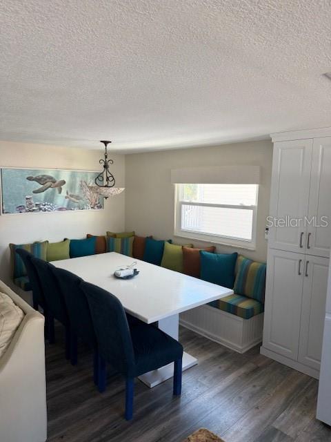 A dining area features a white table, dark chairs, and a built-in corner bench seat — 745 ELDORADO AVENUE, CLEARWATER BEACH, FL