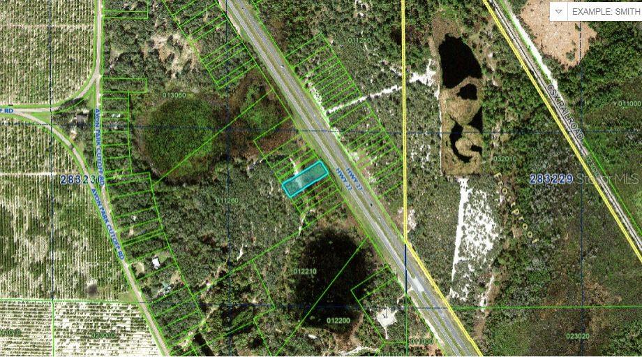 This aerial map shows a highlighted parcel of land located along a highway — US-27, FROSTPROOF, FL