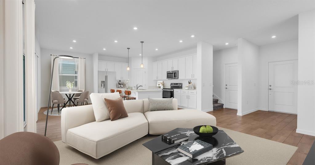This is a digital rendering of an open-concept living room and kitchen with white cabinetry — 3477 SALVIA COURT, TAVARES, FL
