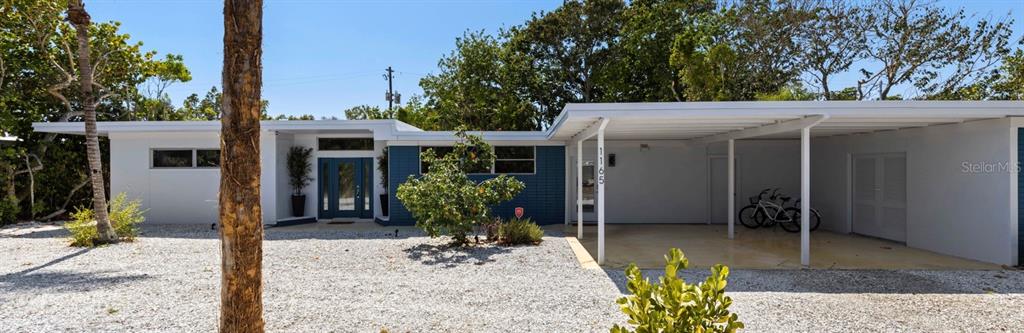 A single-story house with a white exterior, blue accents, and a covered carport — 1165 MORNINGSIDE PLACE, SARASOTA, FL