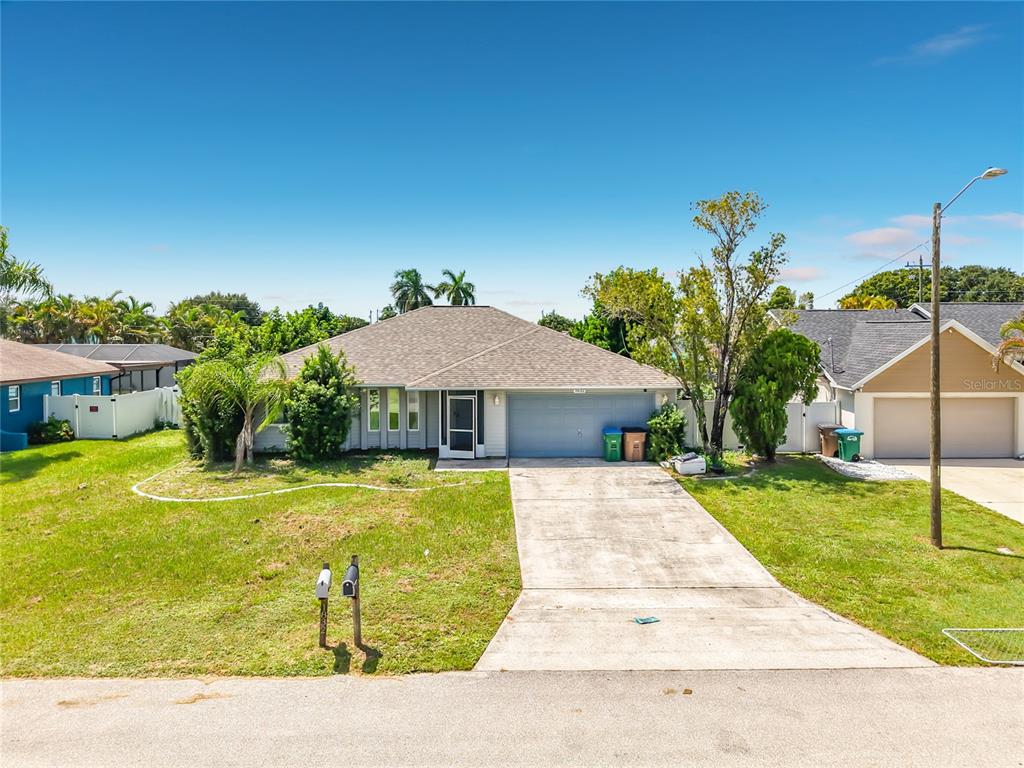 A single-story house with a light-colored facade, a gray roof, and a concrete driveway — 1832 VAN LOON TERRACE, CAPE CORAL, FL
