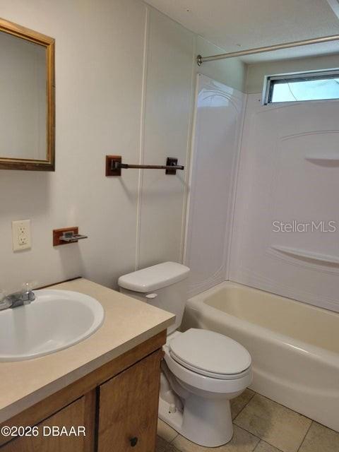 A bathroom features a white pedestal sink, a toilet, and a shower-tub combination — 324 N JANICE LANE, ORMOND BEACH, FL